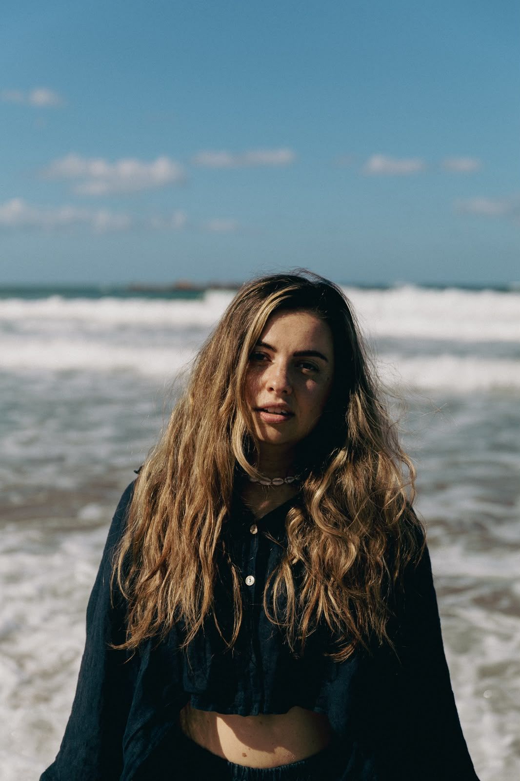 Lucia by the sea, looking straight into the camera